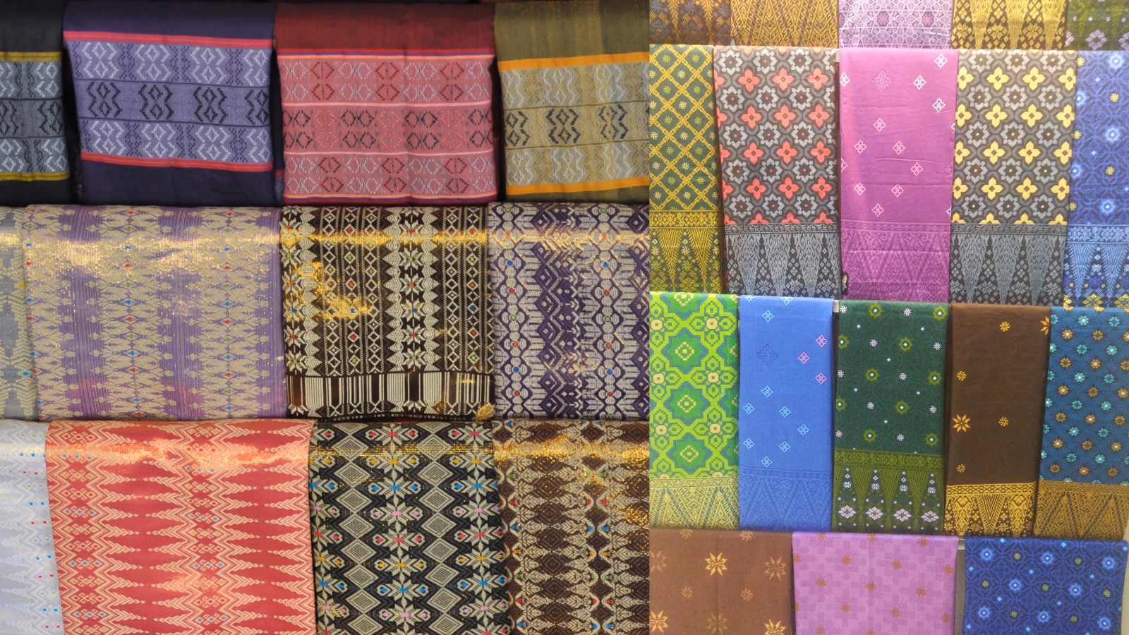 Colorful patterned Balinese textiles displayed side by side